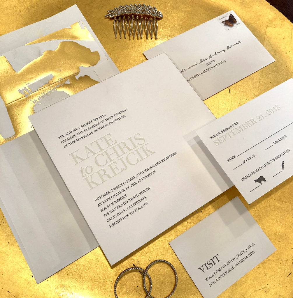 Custom invitations shown printed in letterpress printing with a gold foil liner