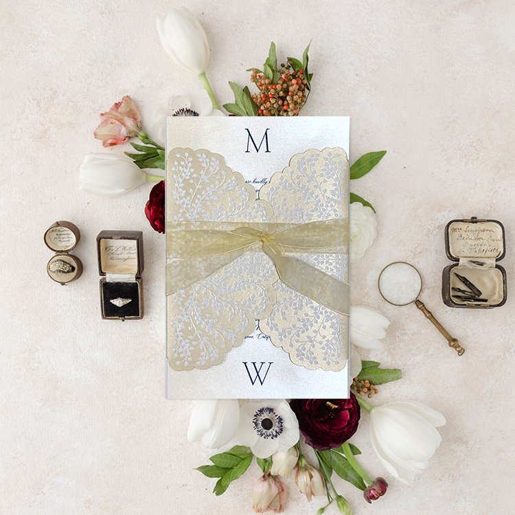 Embossed invitation wrap in champagne gold with navy print