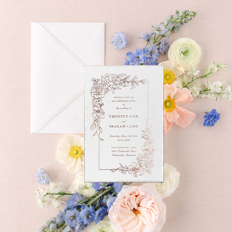 Rose gold foil wedding invitation on a white deckled edge card stock